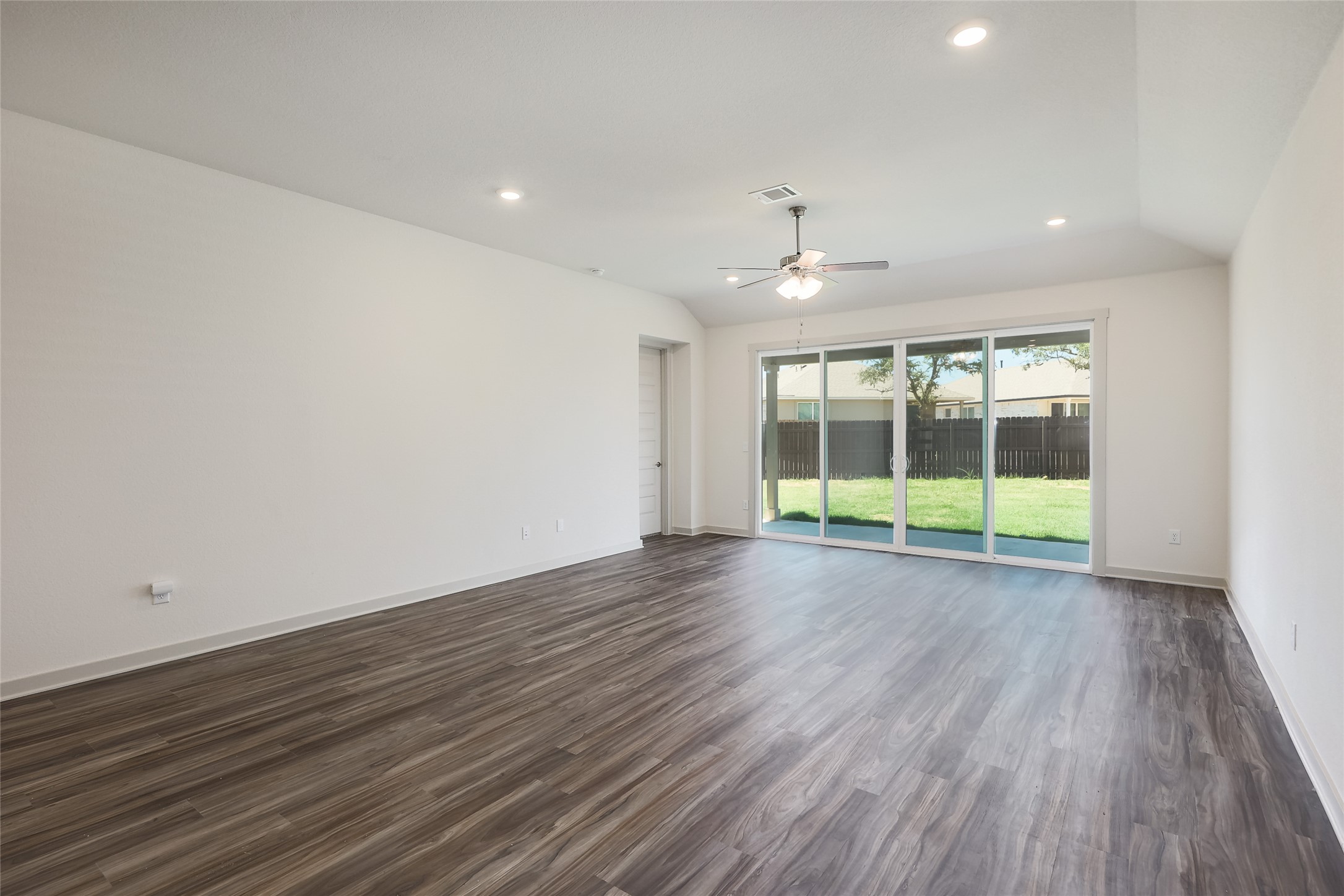 1917 Centerline Lane Georgetown, TX 78628 - Photo 5 of 29 An airy living room with vaulted ceilings and wood flooring, perfect for relaxation or entertaining.