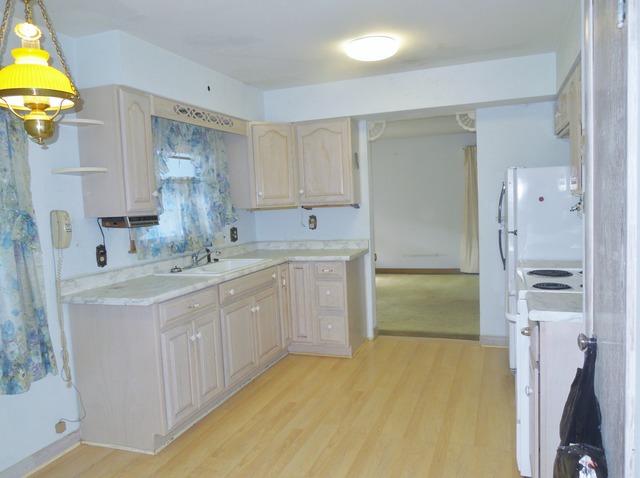 436 Russell Road DeKalb, IL 60115 - Photo 13 of 19 a kitchen with a sink and a refrigerator
