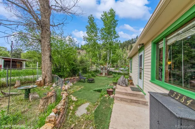 a front view of a house with a yard and potted plants
