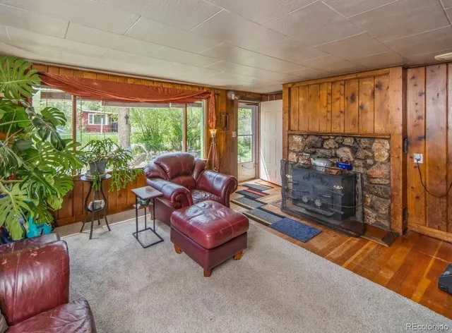 a living room with patio furniture and a floor to ceiling window
