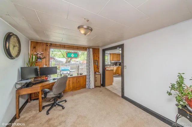 a view of a workspace with furniture and a window