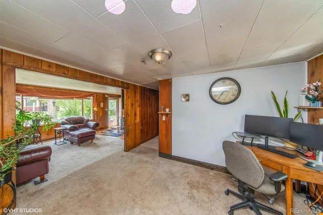 a work room with furniture and a large window