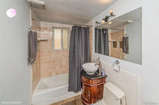 a bathroom with a toilet a sink and a shower