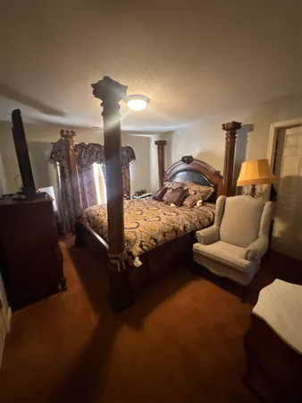 a bedroom with furniture and a lamp