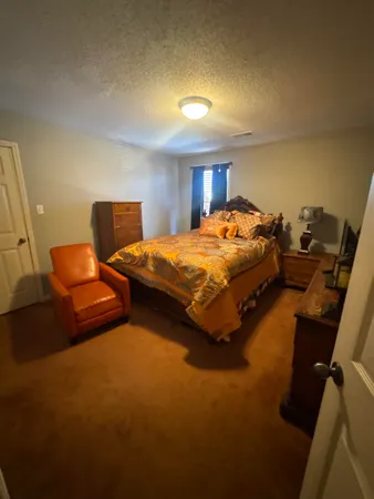 a bedroom with bed and window