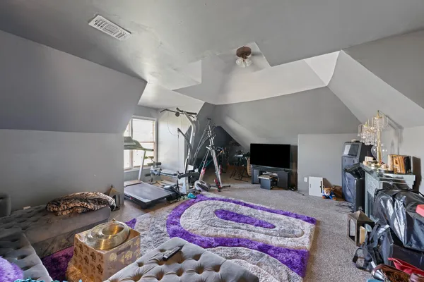 a bedroom with bed and a flat tv screen