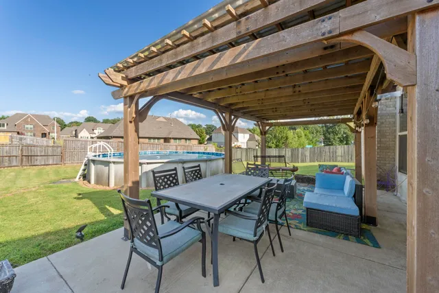 a view of a patio with a table chairs and a table