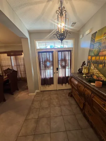 a lobby with furniture and a chandelier