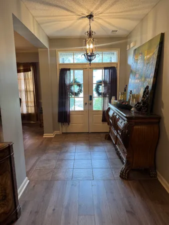 a living room with furniture and a chandelier