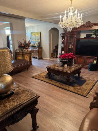 a living room with furniture and a chandelier