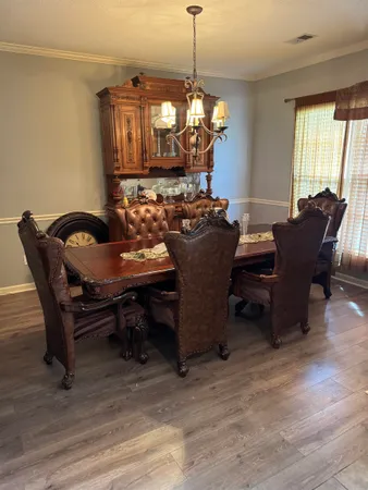 a living room with furniture a fireplace and large windows