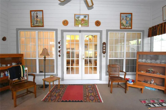 a bedroom with furniture and a large window
