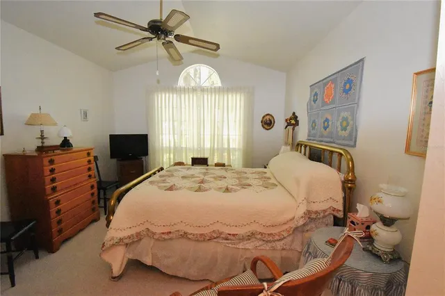 a bedroom with bed and window