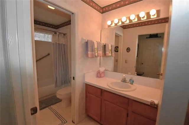 a bathroom with a sink a mirror and a shower