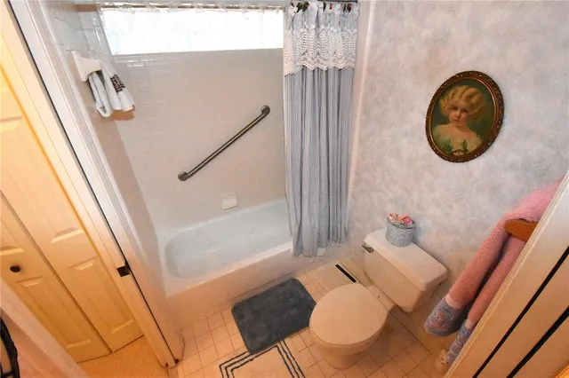 a view of a hallway with furniture and a window