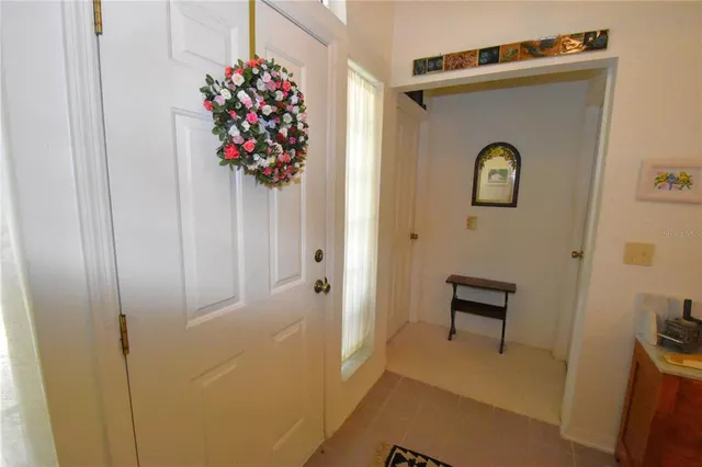 a house view with a hallway to dining room and wooden floor