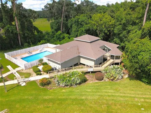 an aerial view of residential house with outdoor space and swimming pool