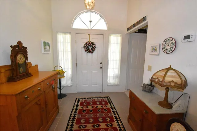a living room with furniture and a mirror