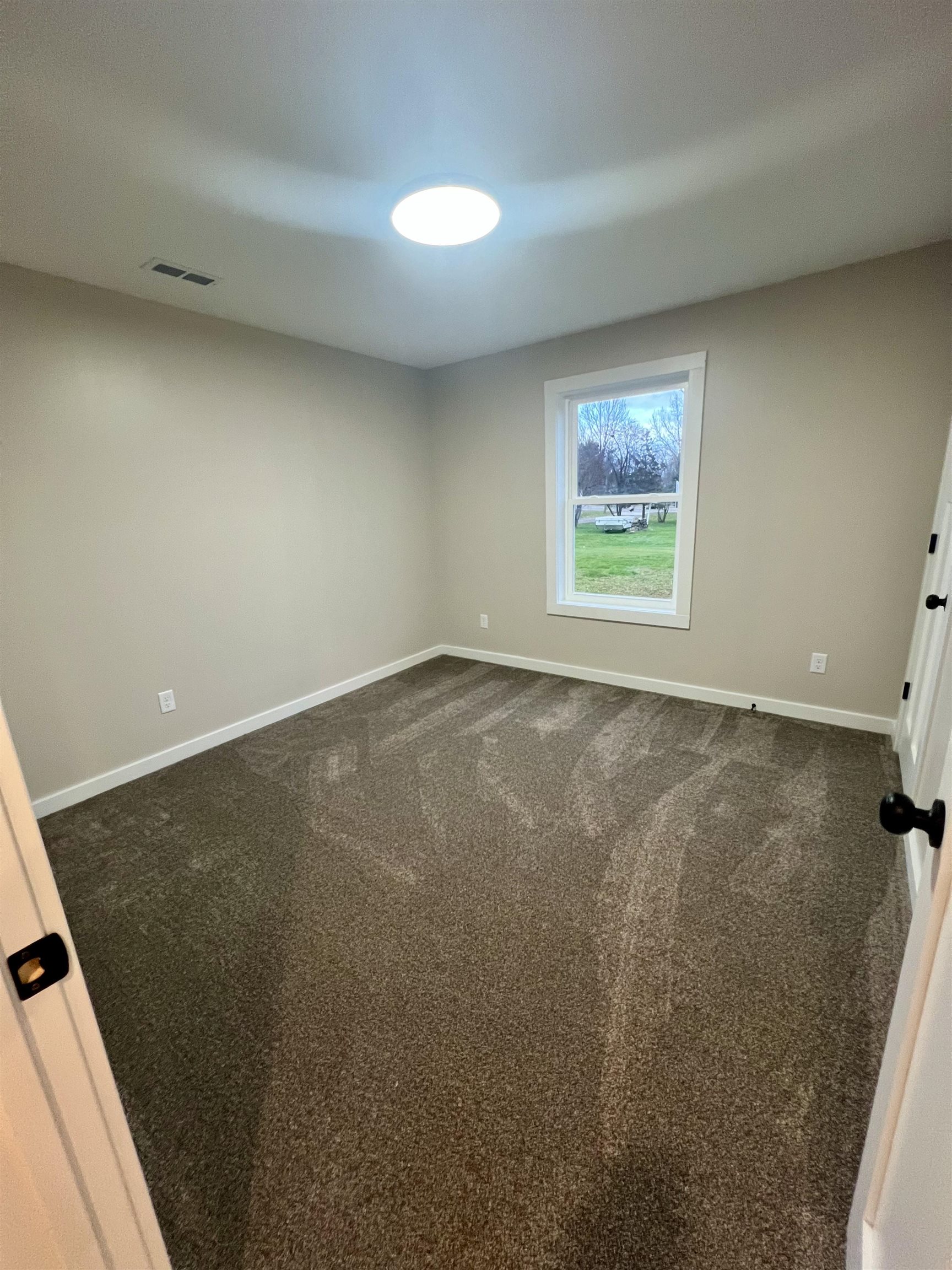 1006 26th Street, Unit B Cloquet, MN 55720 - Photo 13 of 27 Spare room with baseboards and dark colored carpet