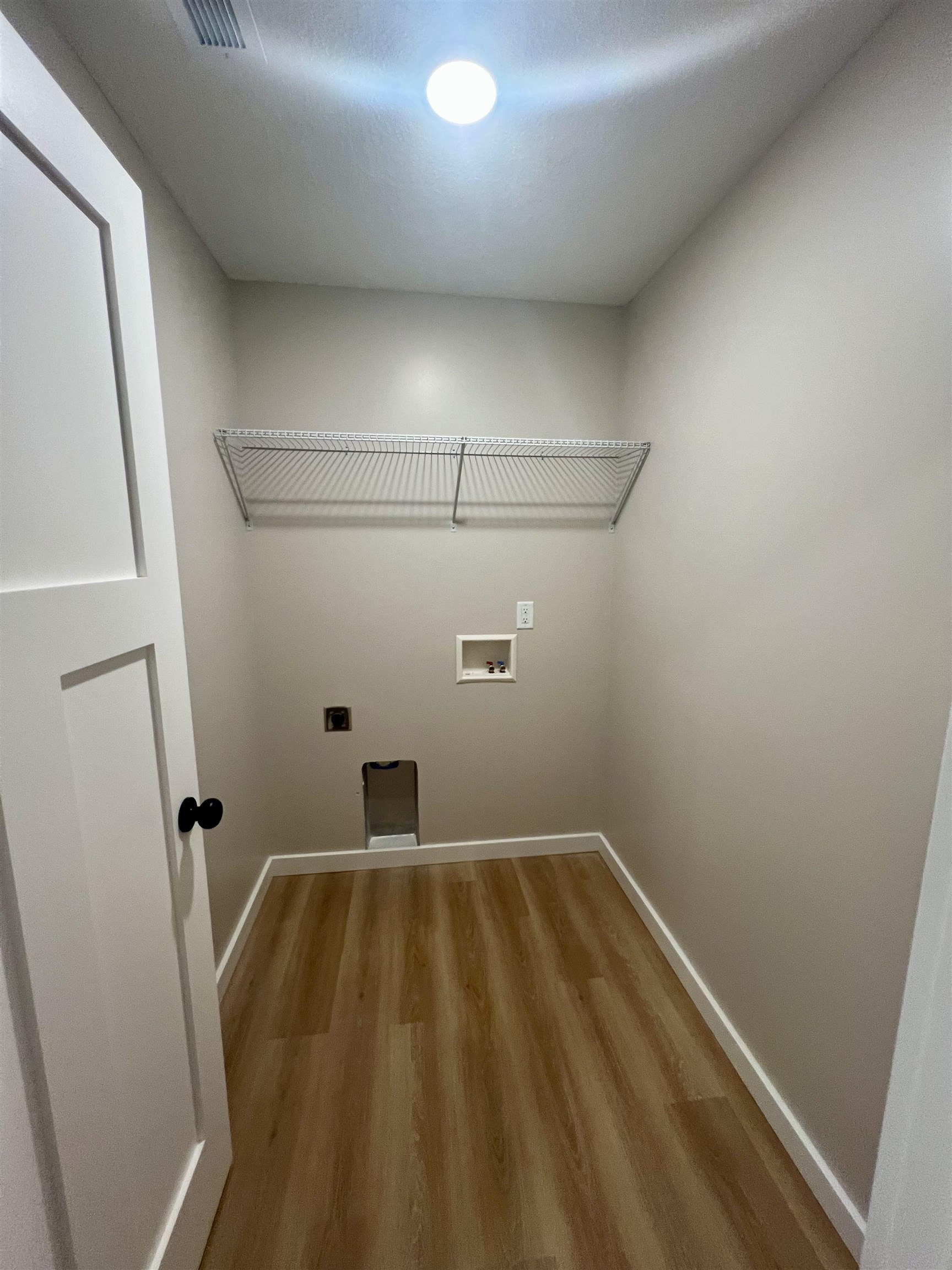 1006 26th Street, Unit B Cloquet, MN 55720 - Photo 24 of 27 Washroom featuring light wood finished floors, washer hookup, and electric dryer hookup