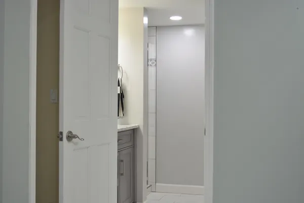 a bathroom with a granite countertop sink vanity and a mirror