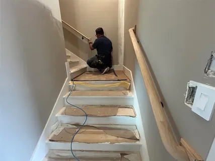 a front view of a building with river and chairs