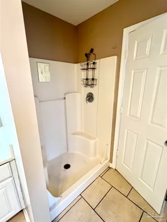 a bathroom with a glass shower door