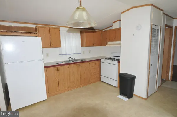 a kitchen with a refrigerator a sink and cabinets