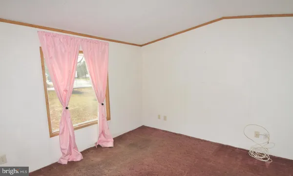 a view of a room with wooden floor and windows