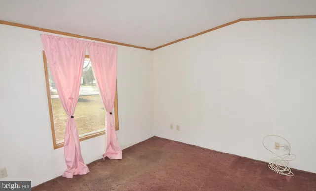 a view of a room with wooden floor and windows