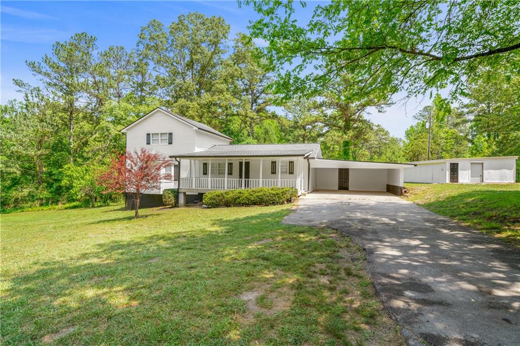 354 Wheeler-Ford Road Rockmart, GA 30153 - Photo 1 of 1 a front view of a house with a yard and garage