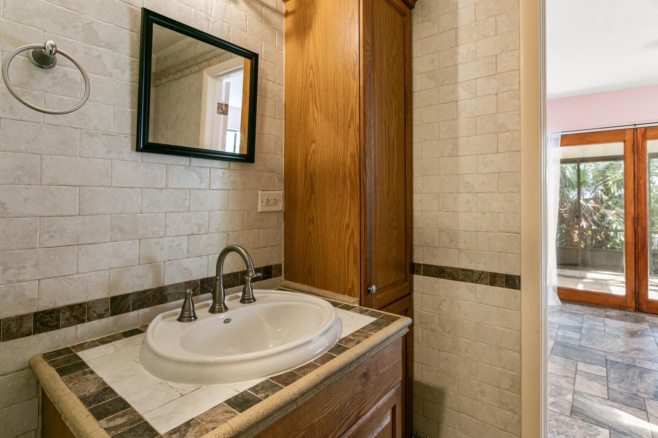 29 Hybiscus Avenue St. Augustine, FL 32084 - Photo 25 of 42 a bathroom with a sink a mirror and a shower