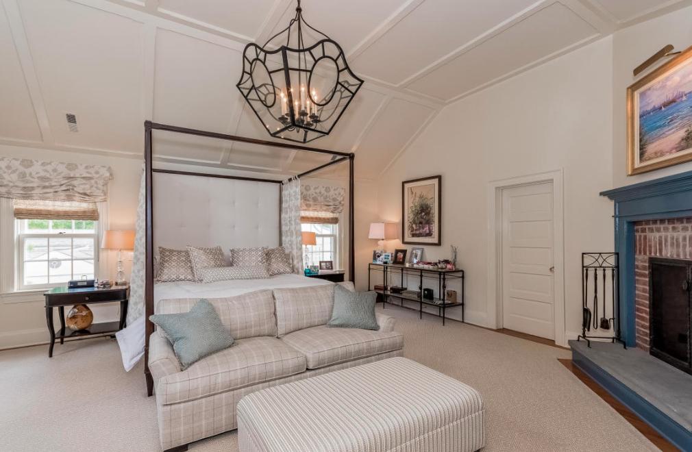 991 Ponus Ridge Road New Canaan, CT 06840 - Photo 7 of 12 a living room with furniture a fireplace and a chandelier