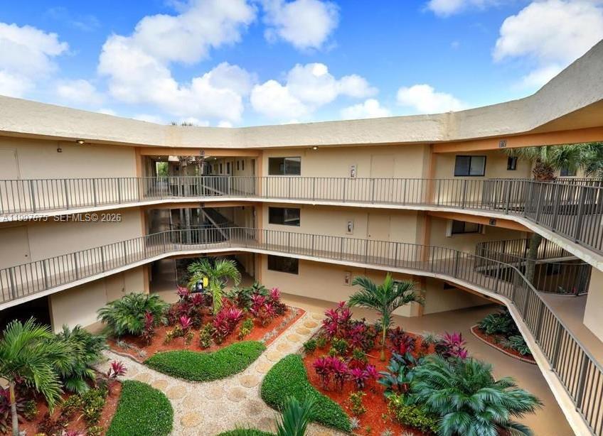 8005 Southwest 107th Avenue, Unit 309 Miami, FL 33173 - Photo 1 of 18 a view of a porch with a flower garden