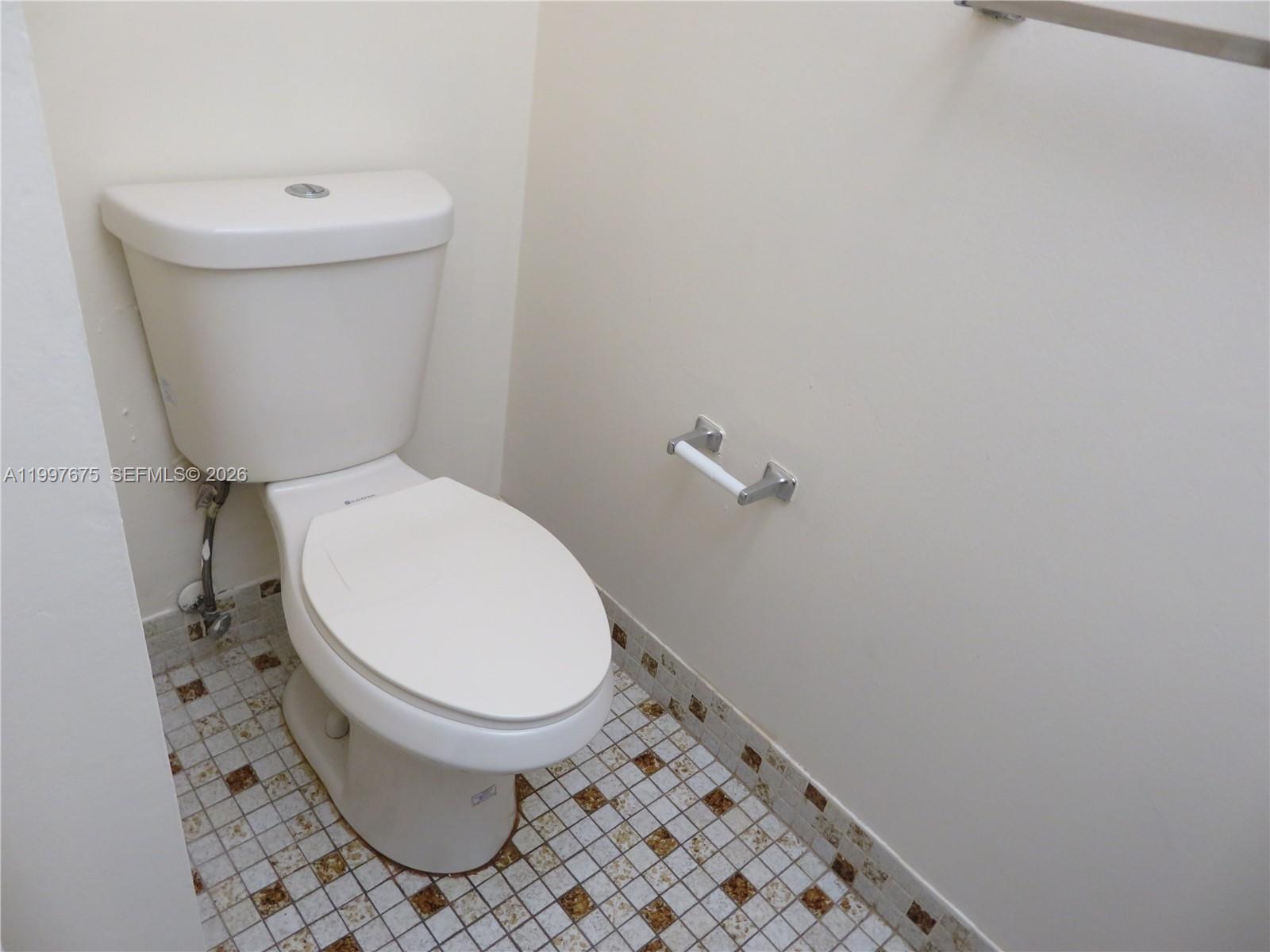 8005 Southwest 107th Avenue, Unit 309 Miami, FL 33173 - Photo 12 of 18 a white toilet sitting next to a small bathroom