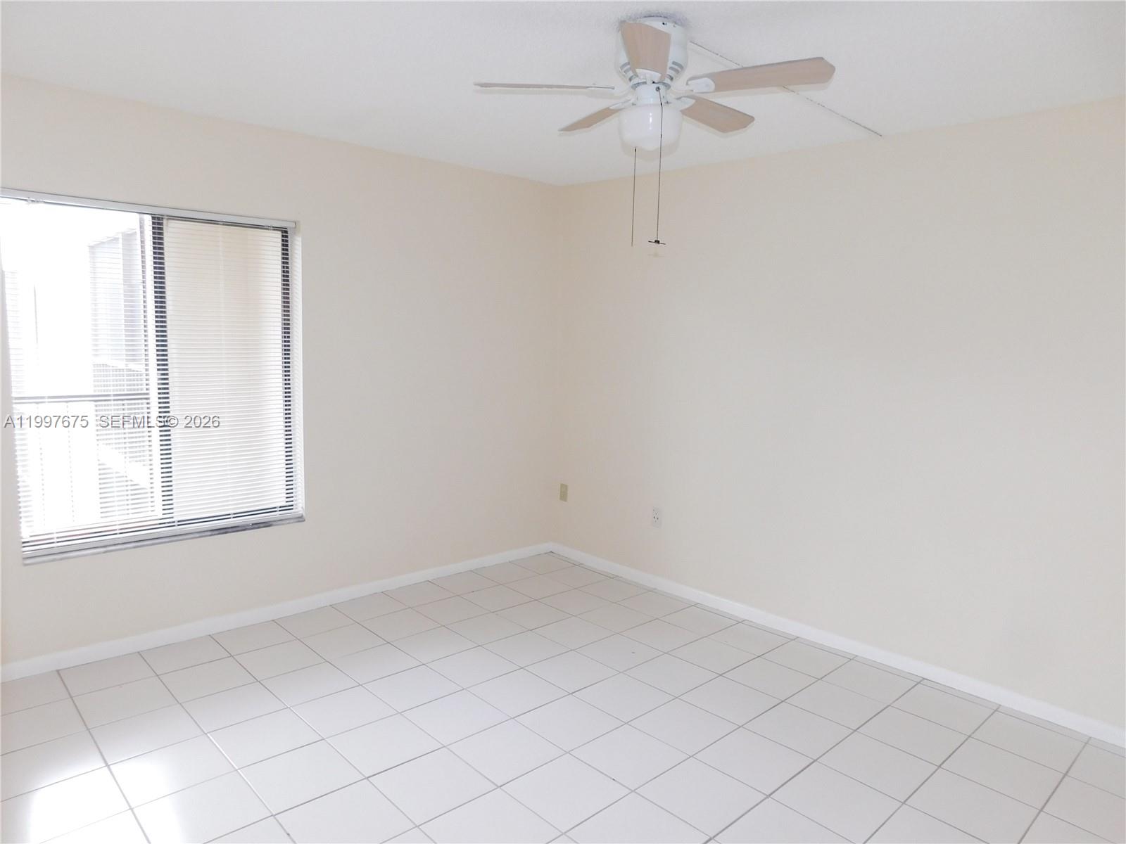 8005 Southwest 107th Avenue, Unit 309 Miami, FL 33173 - Photo 13 of 18 an empty room with a window