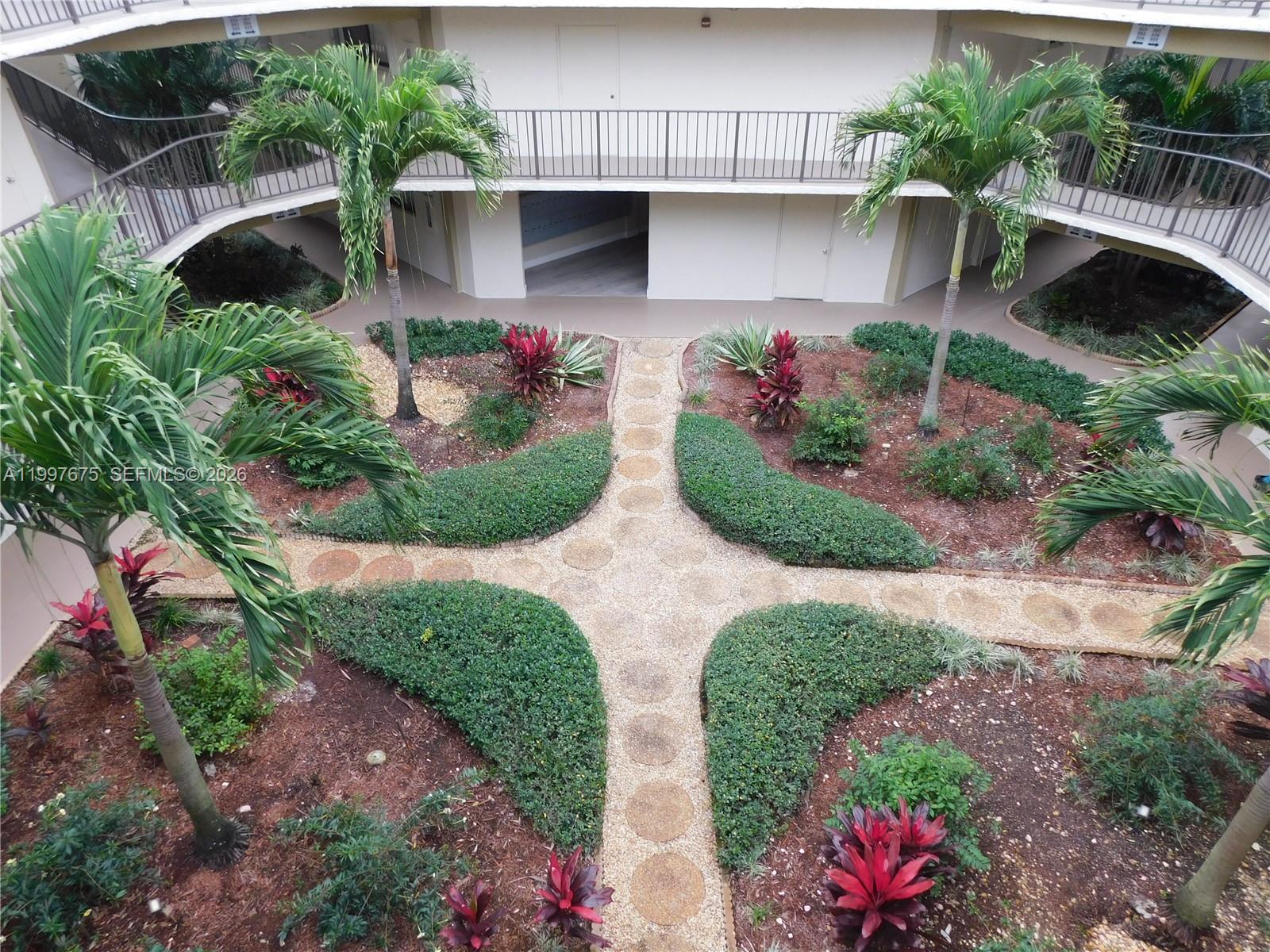 8005 Southwest 107th Avenue, Unit 309 Miami, FL 33173 - Photo 17 of 18 a view of two house with potted plants