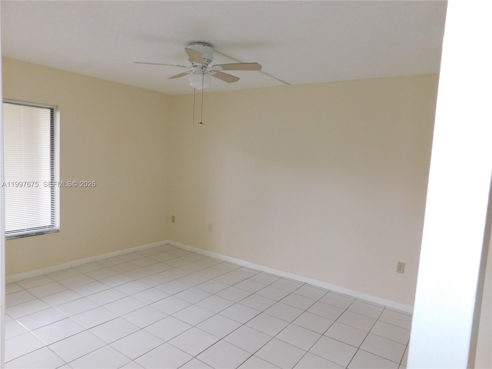 8005 Southwest 107th Avenue, Unit 309 Miami, FL 33173 - Photo 4 of 18 an empty room with a window