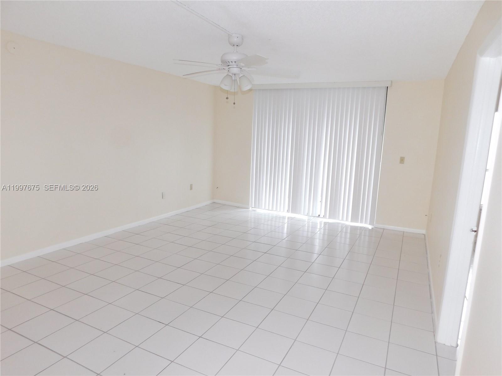 8005 Southwest 107th Avenue, Unit 309 Miami, FL 33173 - Photo 5 of 18 a view of an empty room and window