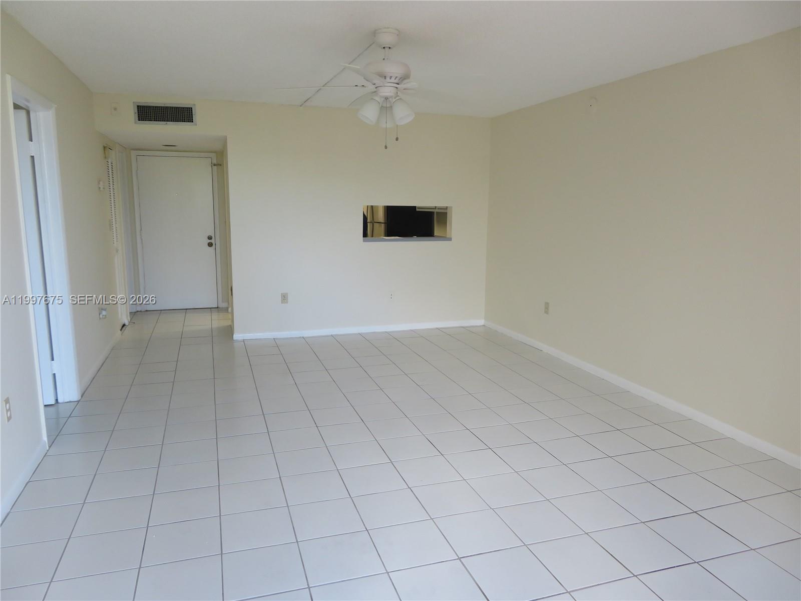 8005 Southwest 107th Avenue, Unit 309 Miami, FL 33173 - Photo 6 of 18 an empty room with a ceiling fan and a window