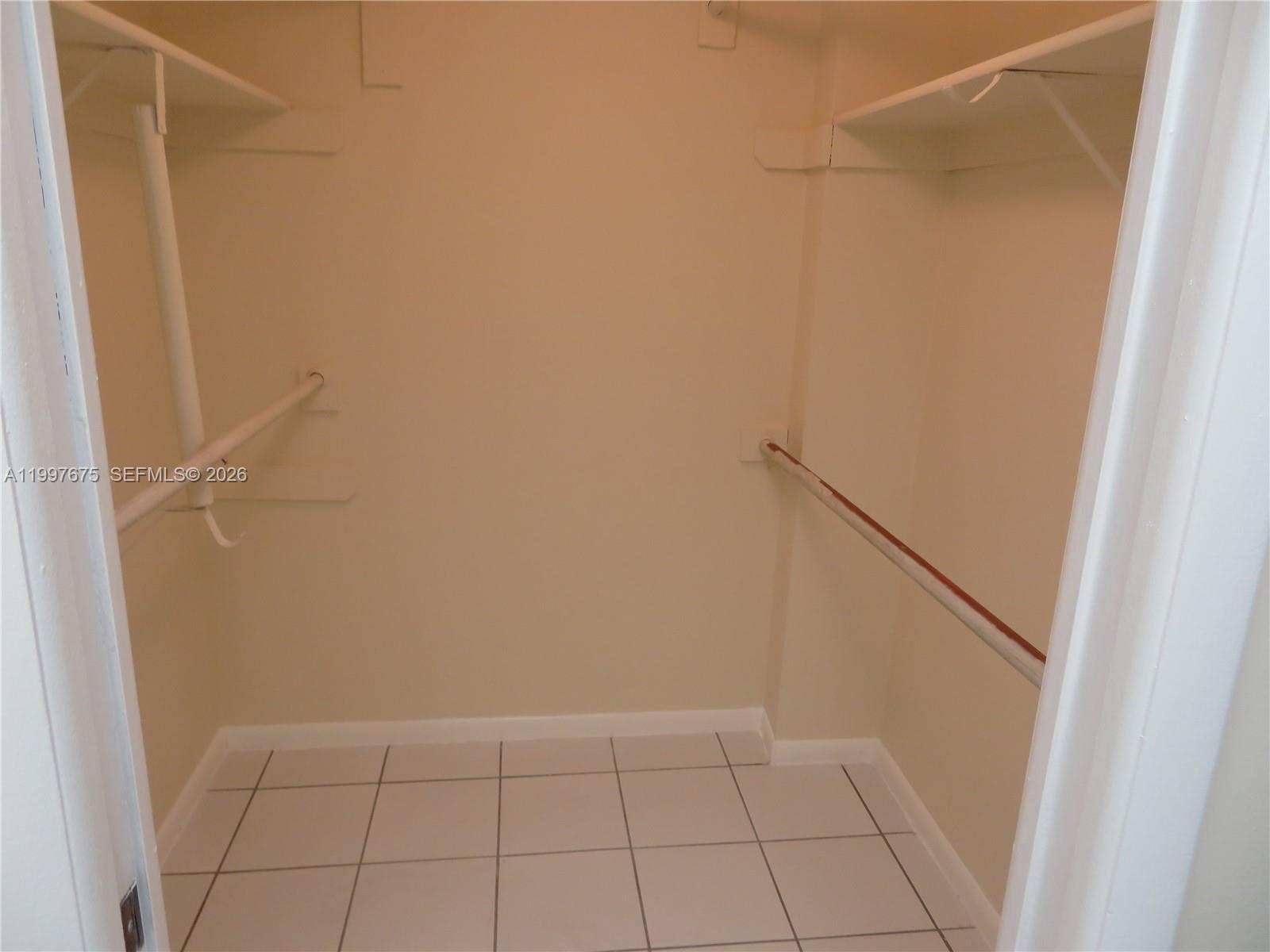 8005 Southwest 107th Avenue, Unit 309 Miami, FL 33173 - Photo 9 of 18 a view of an empty walk in closet