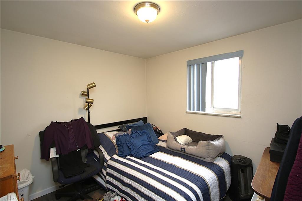 210 Livingston Road West Mifflin, PA 15122 - Photo 8 of 25 a bedroom with a bed and wooden floor