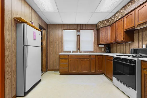 a kitchen with sink a refrigerator and a stove