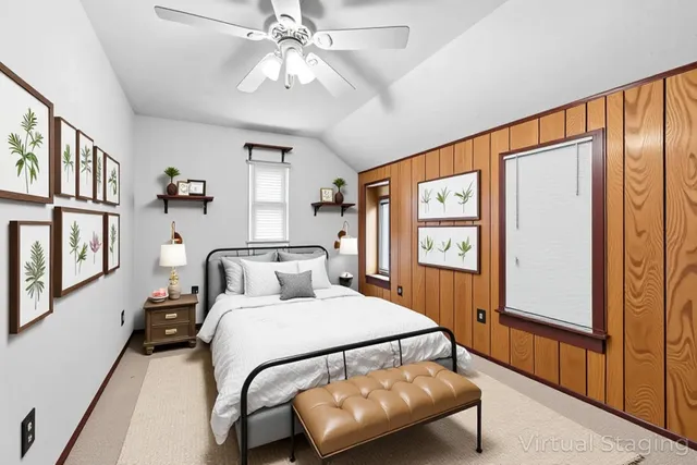 a bedroom with a bed furniture and a large window