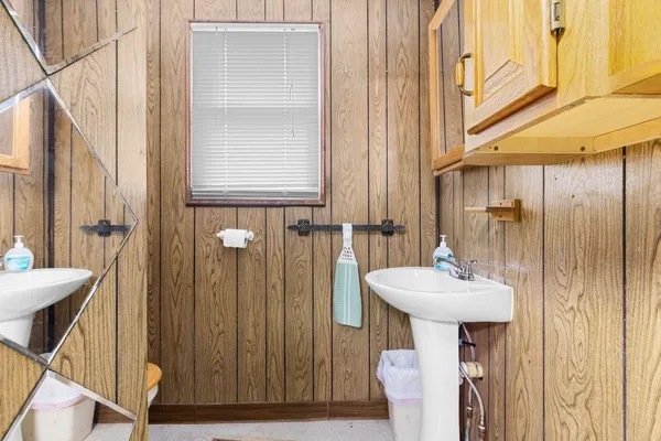 a bathroom with a sink a mirror and shower