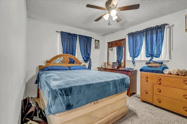 a bedroom with bed and window