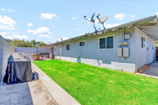 a view of a house with a swimming pool and a yard