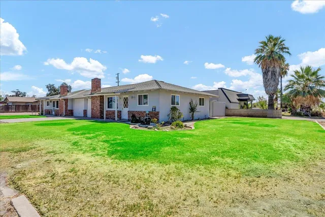 a view of a house with a garden and plants