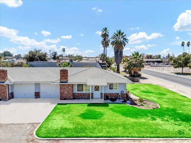 an aerial view of a house with swimming pool garden and patio