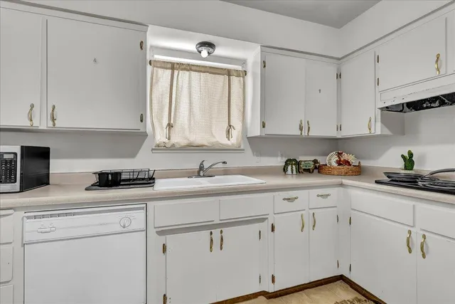 a kitchen with stainless steel appliances granite countertop a refrigerator sink and cabinets